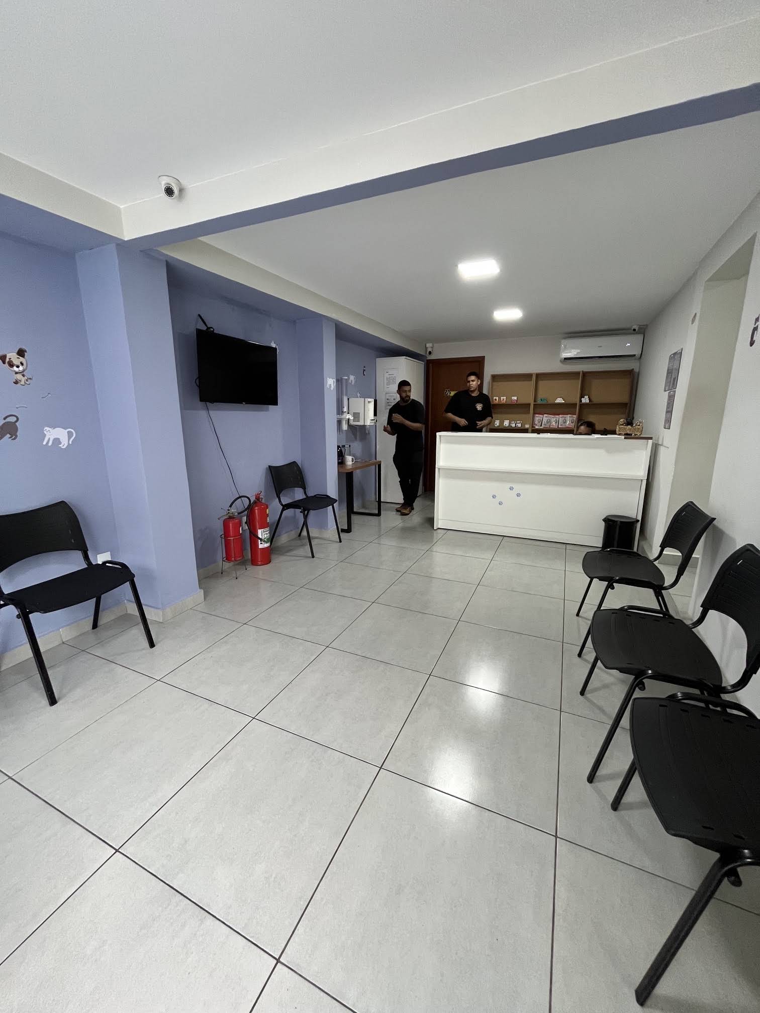 Recepção da AmparaVet, com balcão branco e paredes roxas